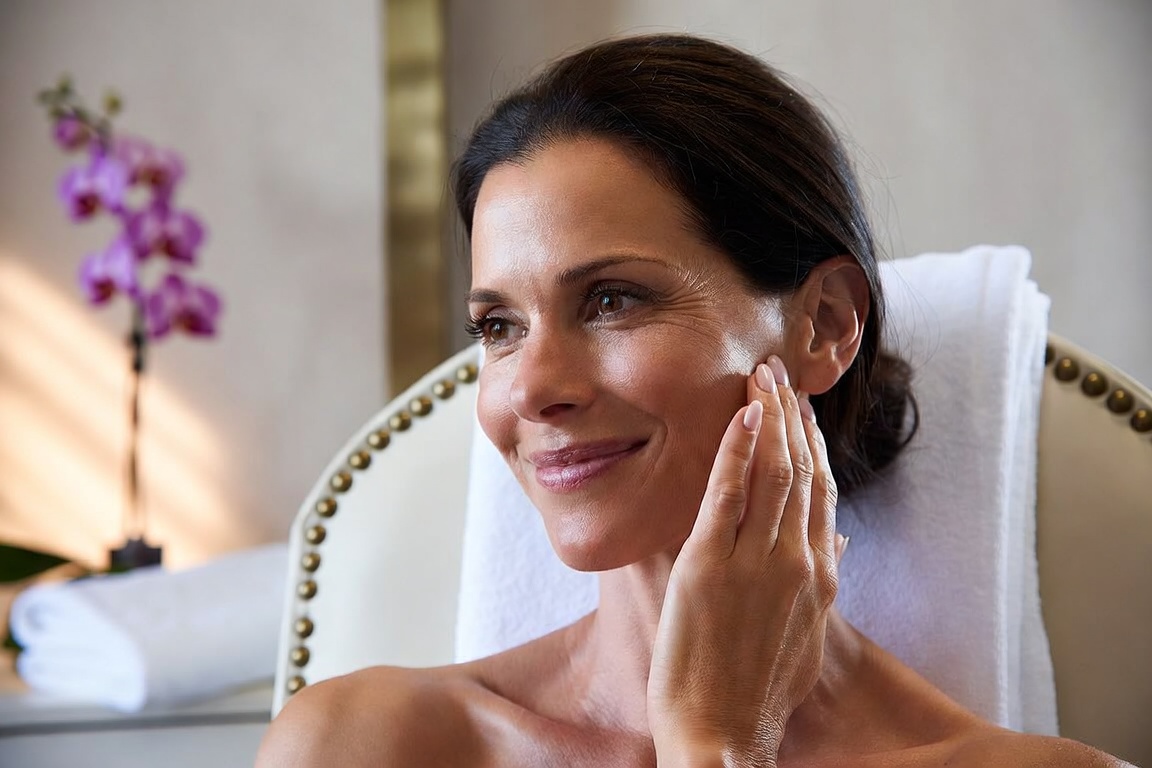 Woman with refreshed, natural-looking skin in a medical aesthetics treatment room in Lincoln, NE